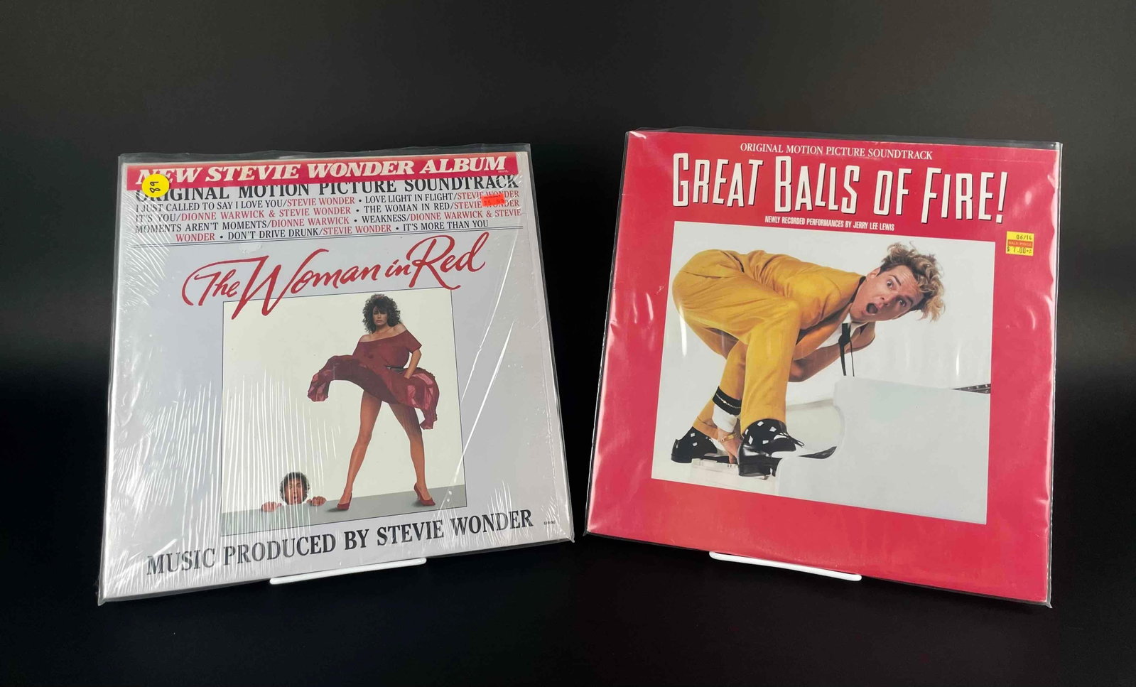 Two Sealed Motion Picture Soundtracks (The Woman in Red, Great Balls of Fire): Original motion picture soundtracks for the films The Woman in Red, and Great Balls of Fire. Both are sealed and in new condition. Please see photos for additional details. Combined Weight: 1.4 lbs Di