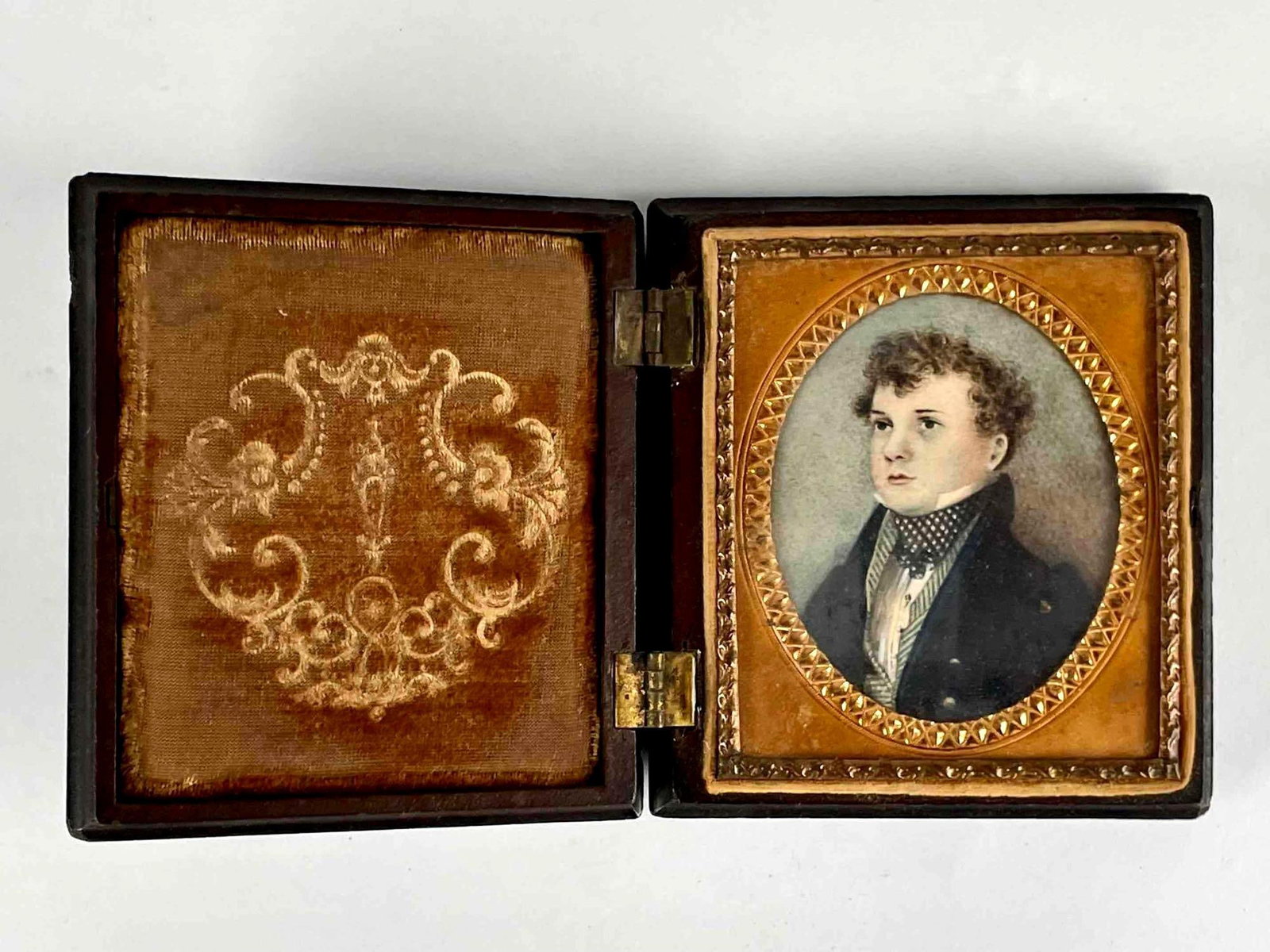 Victorian Wood Folding Travel Portrait: Victorian wood folding travel portrait with shell detail. Case opens up to a yellow velvet interior and a painted portrait of a young man with round frame and gilt detail. From the home of Jon Jacobs,