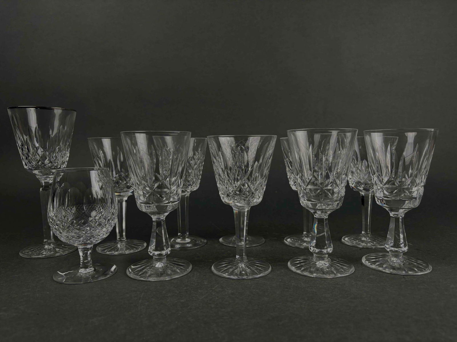 11 Waterford Cut Crystal Glasses (Various Sizes and Patterns): 11 Waterford cut crystal glasses of various sized and patterns. Mixed variety of white wine, red wine, and water goblets. Waterford mark is present on all glasses. Minor signs of surface wear on some