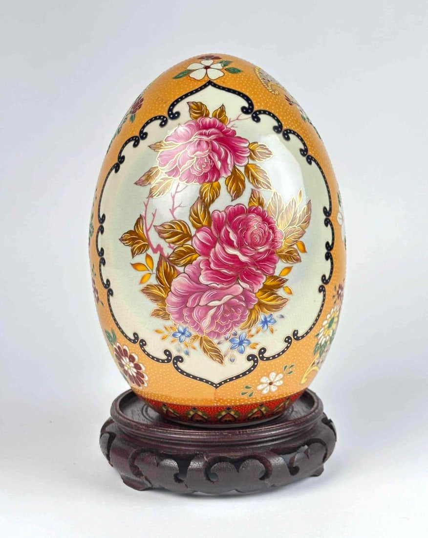 Japanese Satsuma Porcelain Egg: Japanese Satsuma porcelain egg resting on wooden base. Decorated with multicolored flowers with framing around pink roses. In excellent condition. Please see photos for additional details. Dimensions 