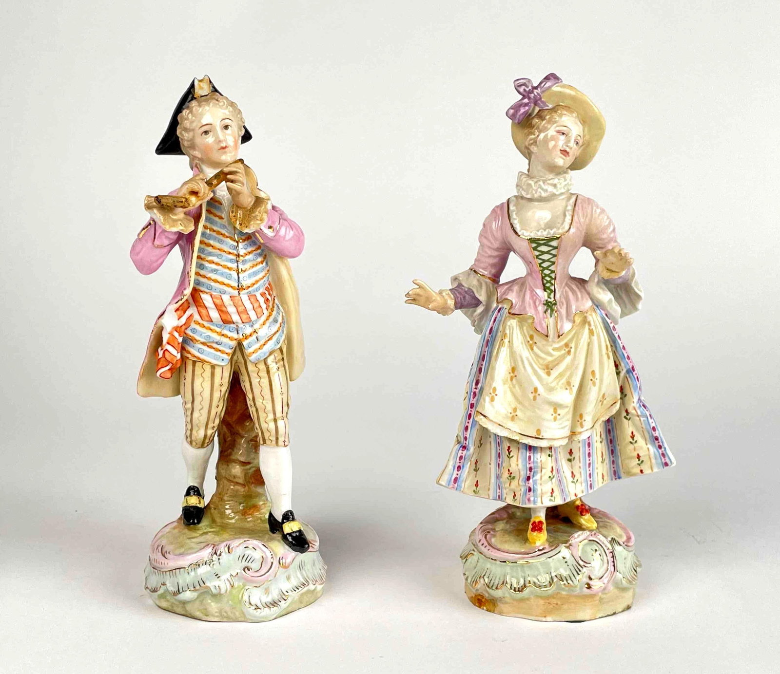Pair of Eighteenth Century Meissen Porcelain Figurines (3314): Pair of eighteenth century porcelain figurines of a woman dancing as the man plays the flute. Blue under glaze hallmark and numbers 3314 are under each. Woman is in excellent condition. Man is in good