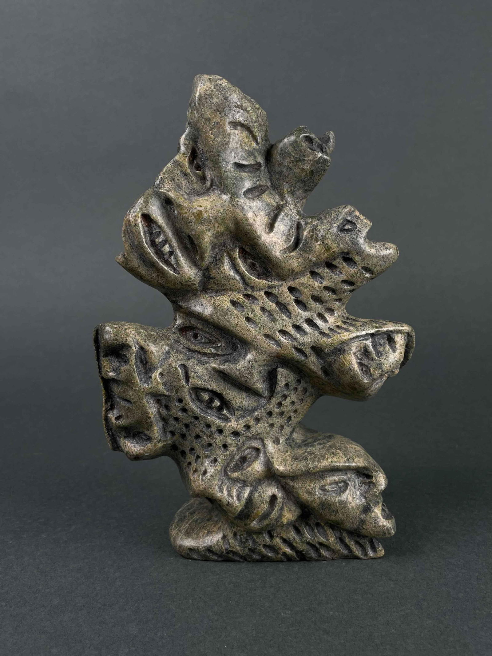 Inuit Spirit Carving (Cape Dorset/Kinngait): Inuit soapstone spirit carving by Tytoosie Tunille. Carving is signed on the foot. Spirit carving is in excellent condition with little to no imperfections. Minor fleabites are present as pictured. Th