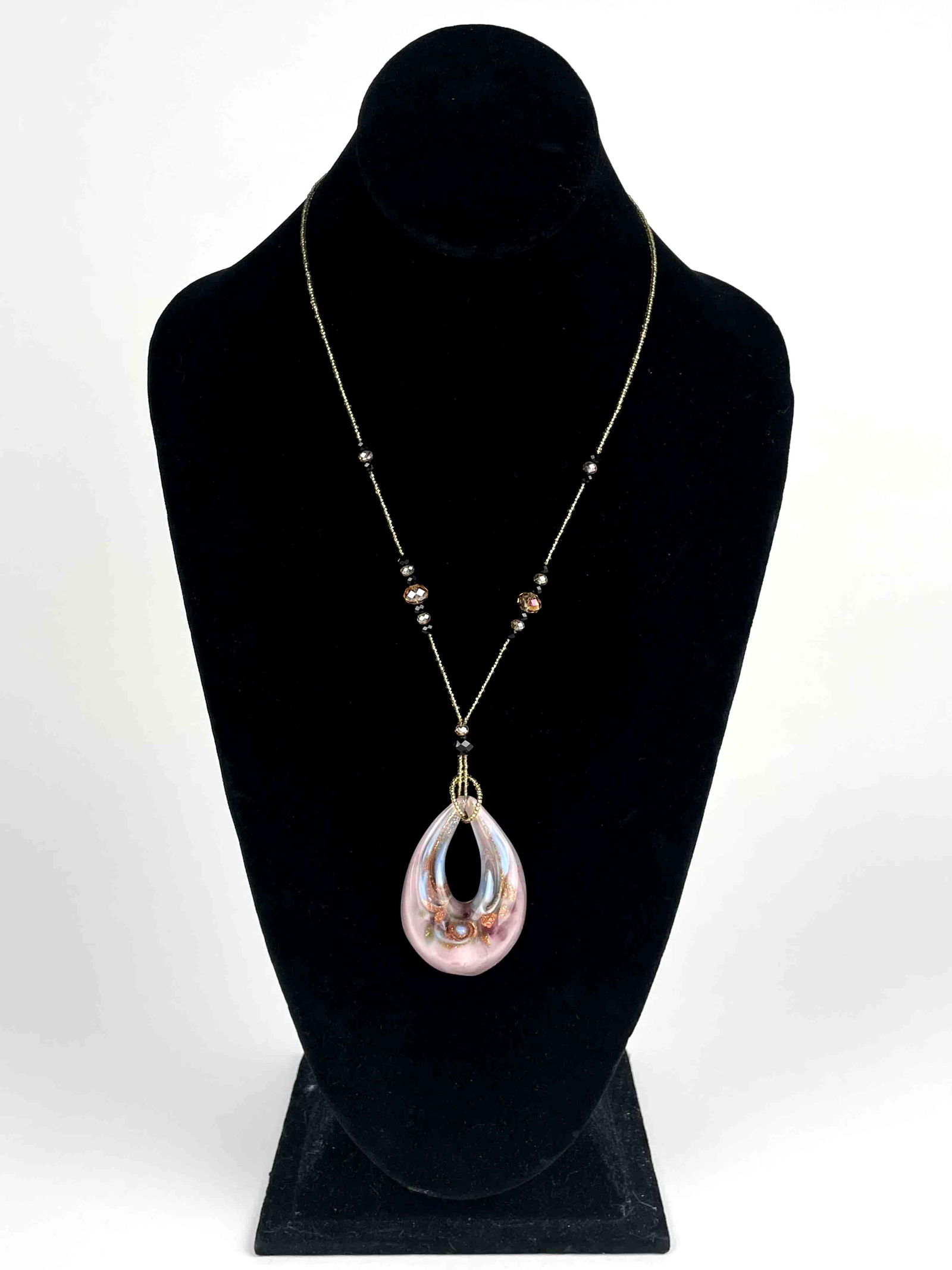 Beaded Necklce with Murano Glass Pendant: Beaded necklace with a Murano glass pendant. Pendant has colors of purple, blue, bronze, and green. Pendant is stamped "Original Murano Glass" on backside. Beads are black and gold toned. Necklace has