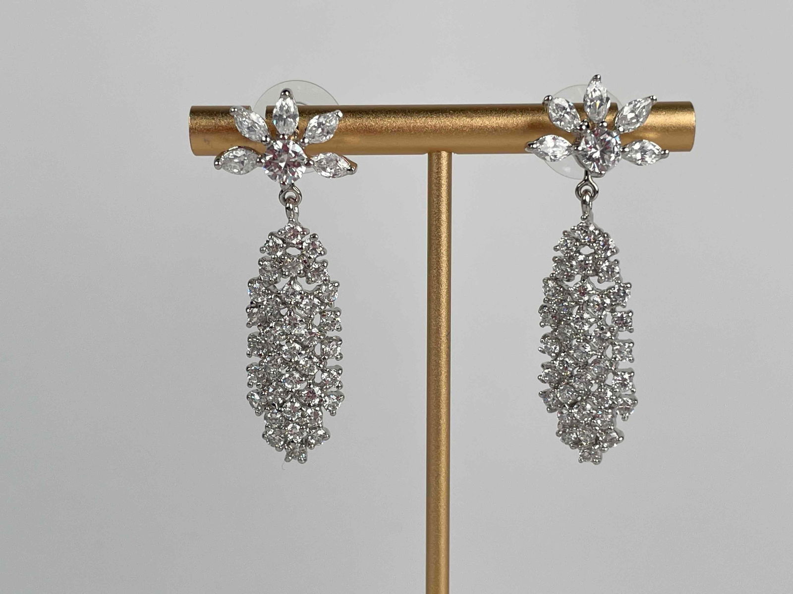 Camrose & Kross Rhinestone Earrings: Pair of Camrose & Kross rhinestone earrings. Earrings have a half sun shaped stud, with a detachable dangling cluster. Hallmark present on back of posts. Please see photos for additional details. Dime