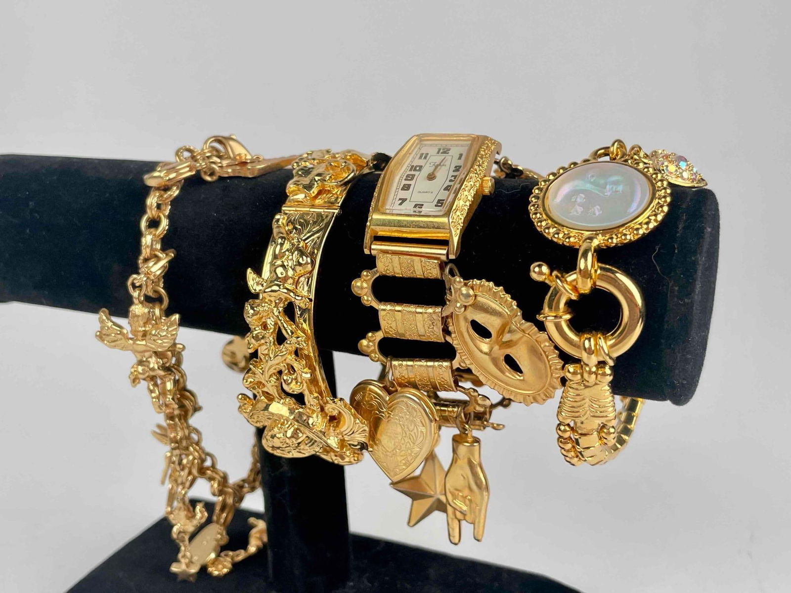 Four Kirks Folly Costume Jewelry Bracelets: Four costume jewelry bracelets from Kirks Folly. Excellent condition. Charm bracelets and watches with fairy dust styling. Please see photos for additional details. Dimensions Longest (charm bracelet)