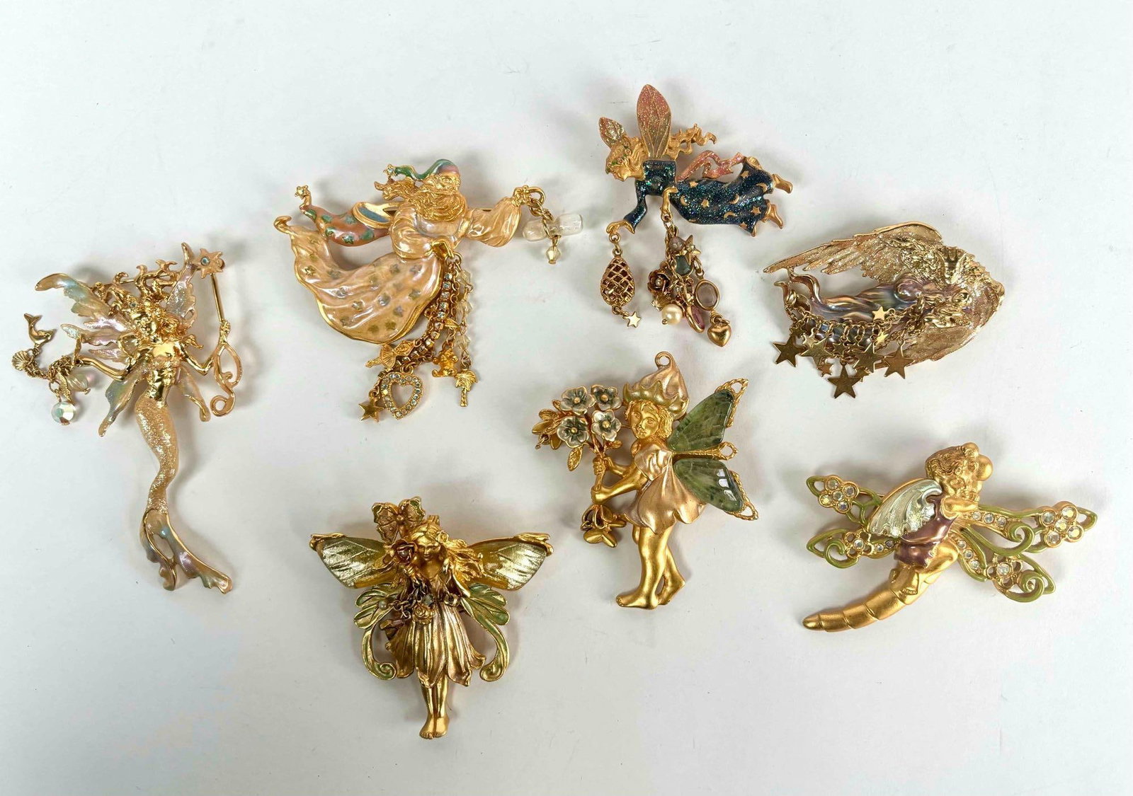 Collection of 7 Kirks Folly Faerie Pins: Seven Kirks Folly faerie pins. All pins are named on the reverse. Pins depict different types of faeries with rhinestone and enamel embelishments. All pieces are in excellent condition. Please see pho