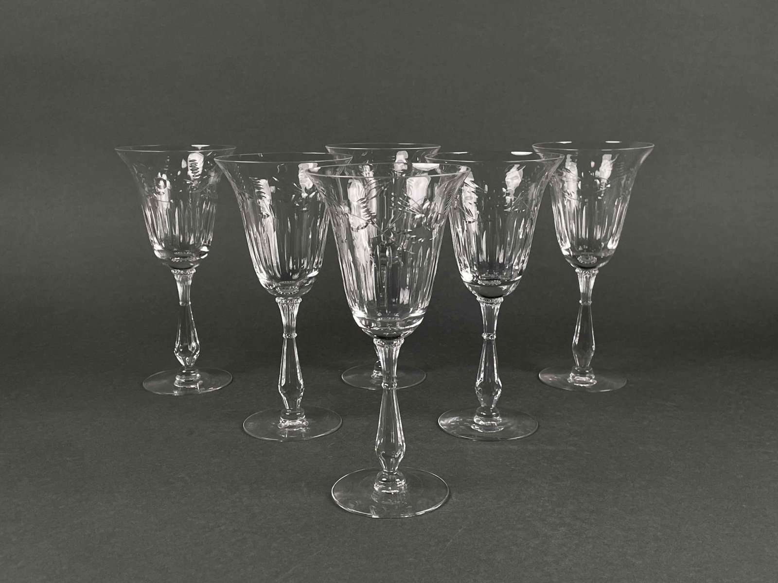 Set of Six Crystal Wine Glasses: Set of six crystal wine classes with floral detailing. In good condition. One glass has a small chip in rim as documented in photos. Please see photos for additional details. Dimensions: 4" x 8" x 8" 