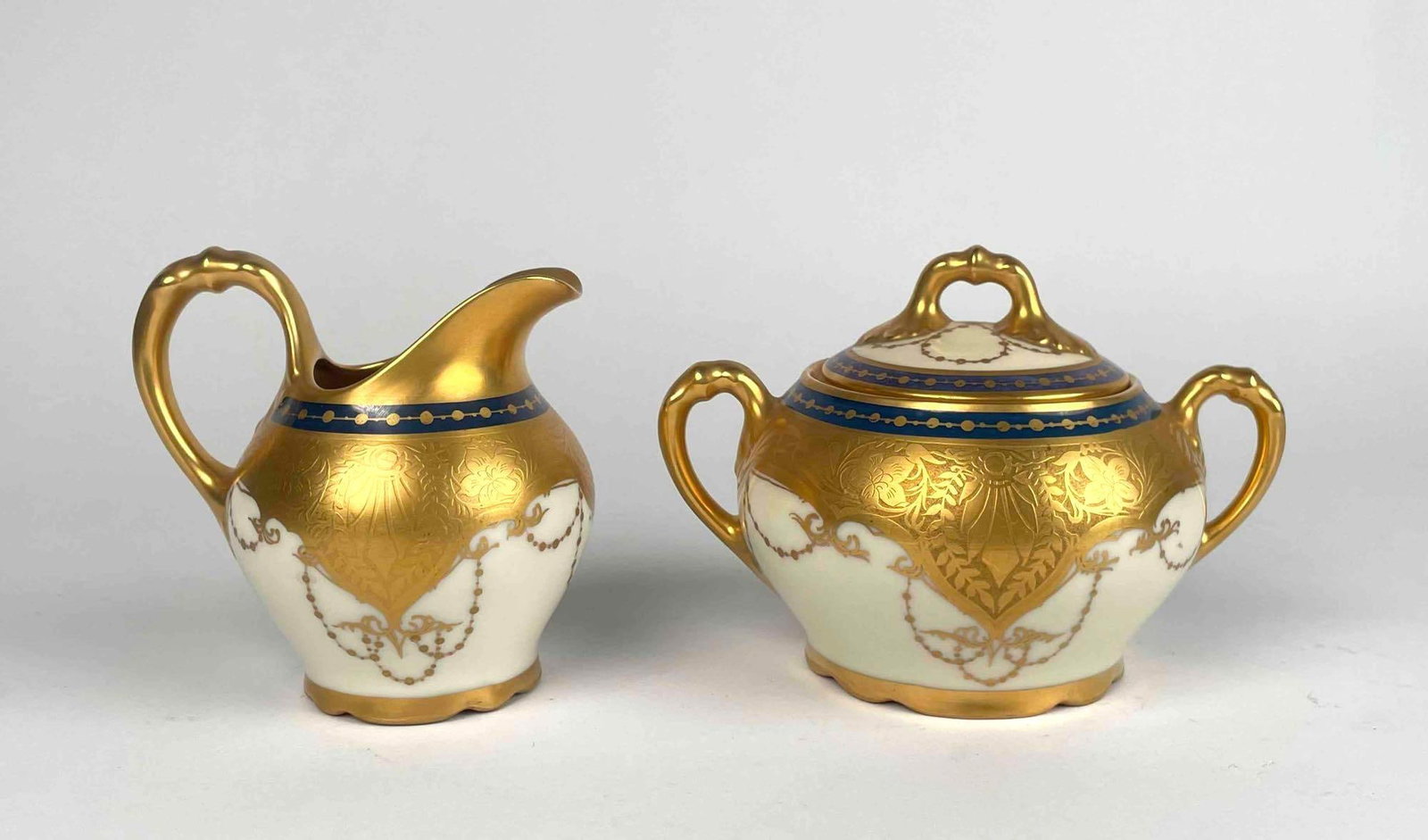 Bavarian Signed Osborne Schwarzburg Pitcher and Sugar Bowl: A pair of signed Bavarian Osborne Schwarzburg pitcher and sugar bowl. Porcelain with blue and gilted detail. Schwarzburg hallmark is located on base. "Osborne" signature incised into base. In good con