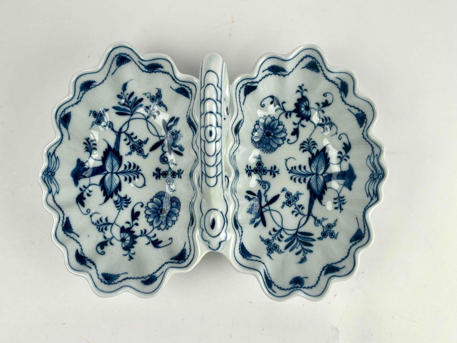Blue Danube Scalloped Serving Dish: Blue Danube double serving dish. Dish has scalloped edges and decorative handle. Blue and white motif. No chips, scratches, or cracks. Hallmarks to underside. Please see photos for additional details.