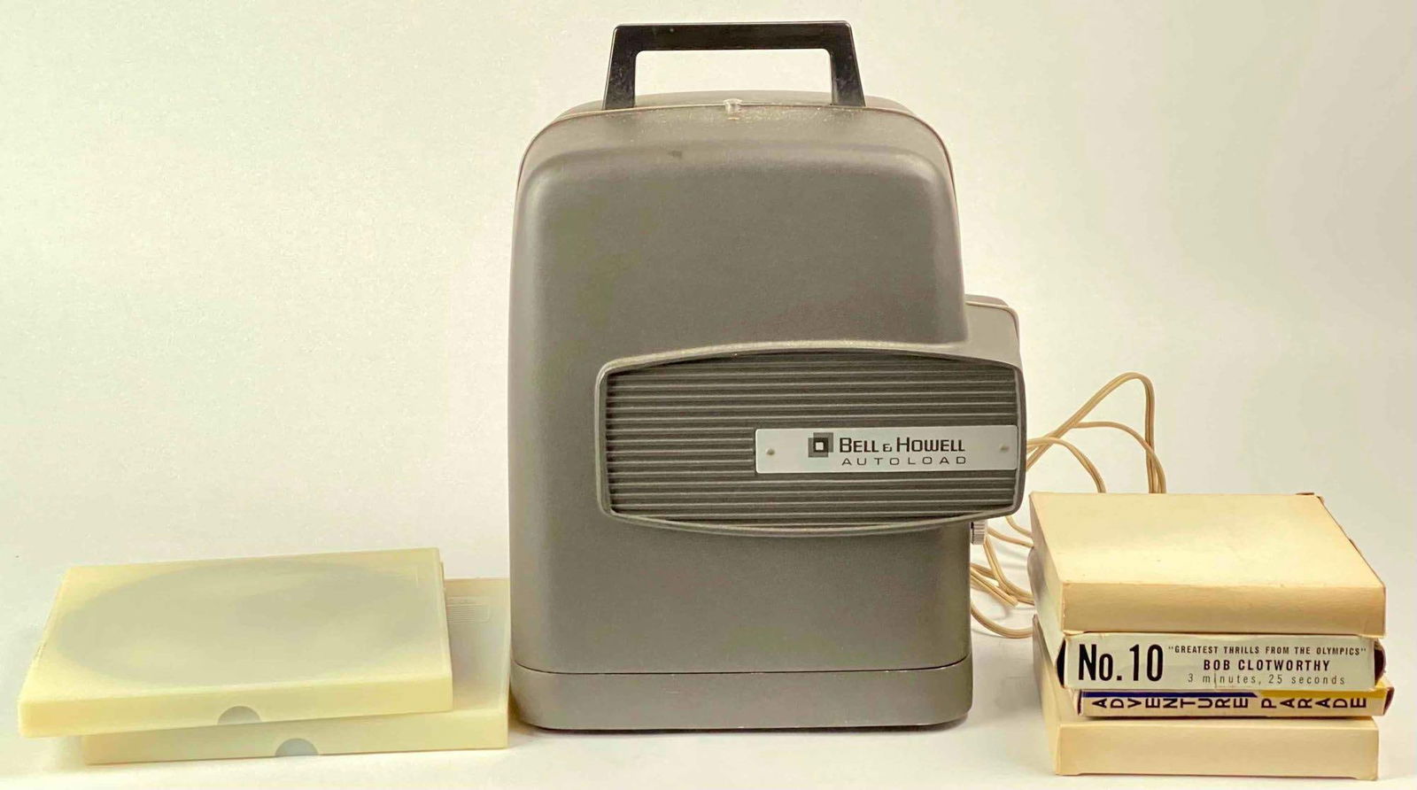 Vintage Bell and Howell Projector and Films: Vintage Bell and Howell Projector and films. Lot is in good condition. Please see photos for additional details. Dimensions of projector: " x " Film Boxes: " x " x 1" Total Weight: 5.8lbs Please note