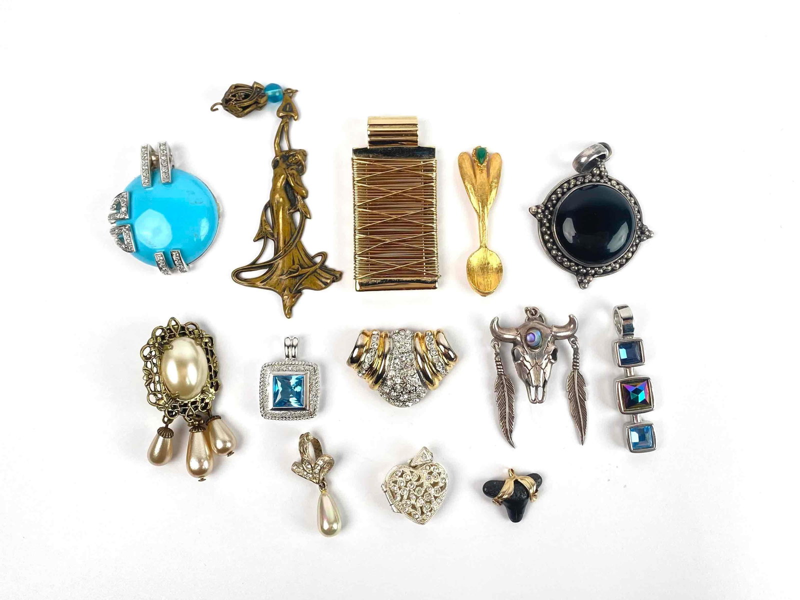 Group of Assorted Pendants (Sterling Silver): Assorted pendants of various designs and makers. Includes round sterling silver pendants with turquoise and onyx, as well as a sterling silver and Mother of Pearl bull skull pendant, and blue topaz se