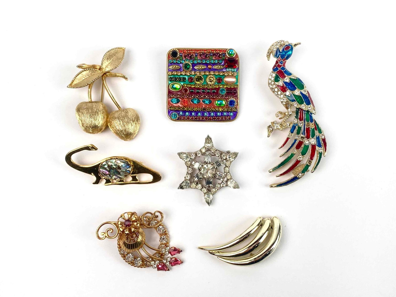 Group of Costume Jewelry brooches: Group of assorted costume jewelry brooches of various makers and designs. Includes: One multicolor enamel and rhinestone Peacock brooch. Brooch is on gold toned hardware. Brooch is in good condition w