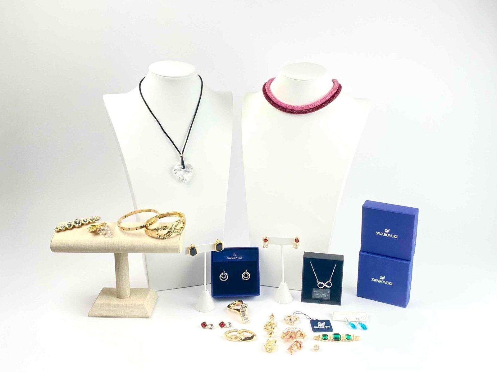 Group of Costume Jewelry (Swarovski, J, Lara Roes): Group of costume jewelry by makers such as Swarovski, JP, Sal, and Lara Roes. Includes: Two cable pink and red cable necklaces by Swarovski. Comes in original box. Pair of Swarovski hoop dangle earrin
