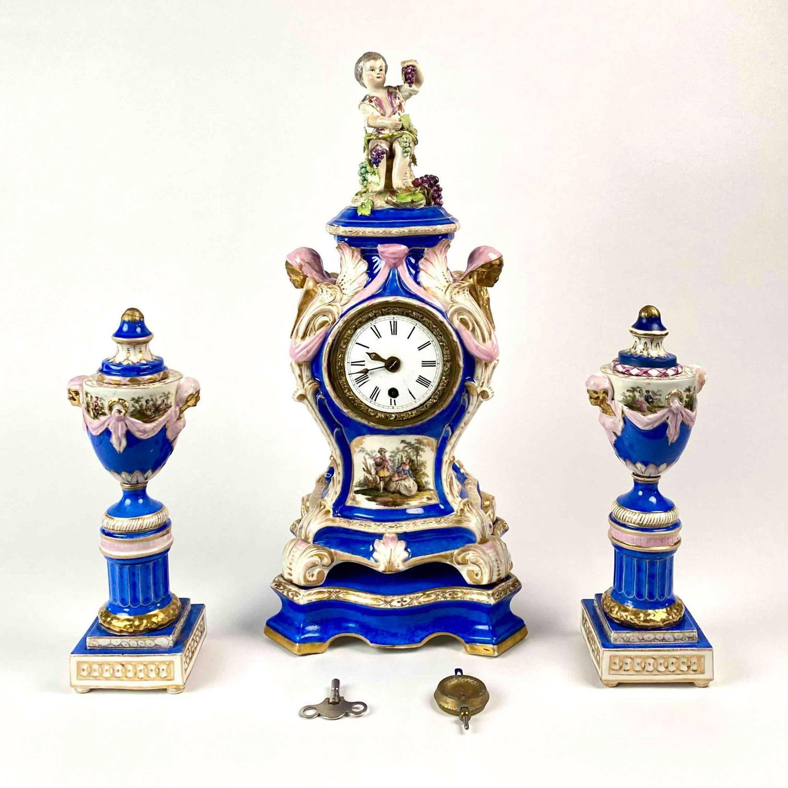 Antique Meissen Mantle Clock and Matching Candlesticks: Blue Meissen Clock and Matching Candlesticks. Also included: Weight and Key. Lot is in good to excellent condition. Please see photos for additional details. Dimensions of Candle Sticks: 10.5" x 3" x