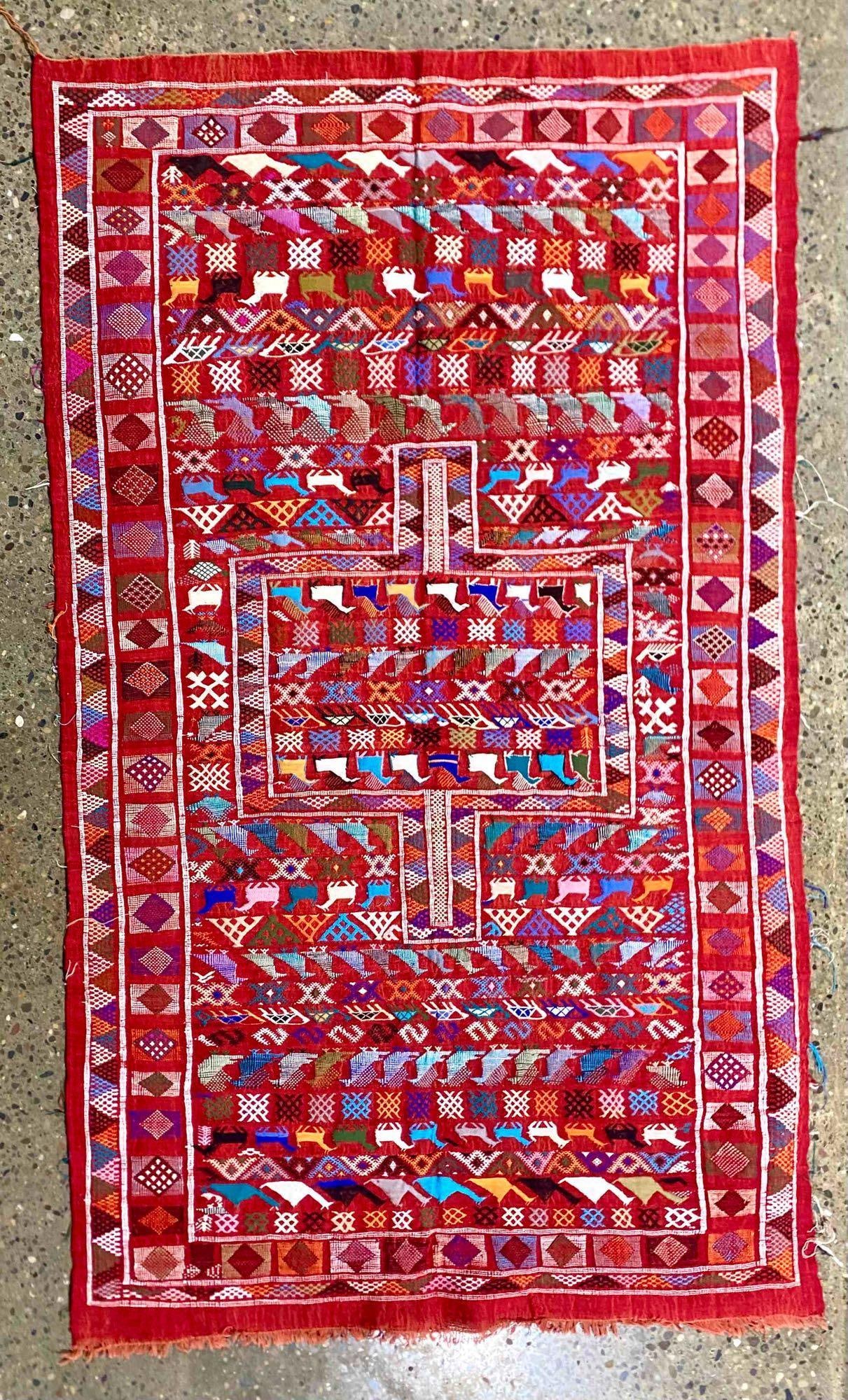 Handwoven Kilim Area Rug (Morocco): Handwoven Kilim from Morocco. Textile features vibrant geometric patterns, animal motifs in bold reds, blues, and other bright tones. Kilim is in good condition. Please see photos for additional photo