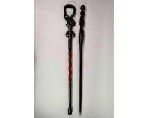 Set of Two Hand-Carved African-Style Wooden Walking Sticks: A pair of hand-carved walking sticks in African-inspired designs, crafted from dark wood. The first features a loop handle above an elephant, with two elephant head carvings and an ornate twisted sect
