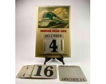 Missouri Pacific Lines Perpetual Calendar: Tin perpetual calendar from Missouri Pacific Lines. Calander features an image of a train on the front and an assortmentÂ of cards with numbers and monthsÂ to change the date on th