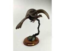 Greg O’Neal (American, 20th -21st century) Fly Down Bronze Statue: Fly Down patinated cast bronze statue by Greg O’Neal. Statue is signed and dated, and mounted on wood base with National Wild Turkey Federation inlayed logo and brass artist plaque as pictured. Item