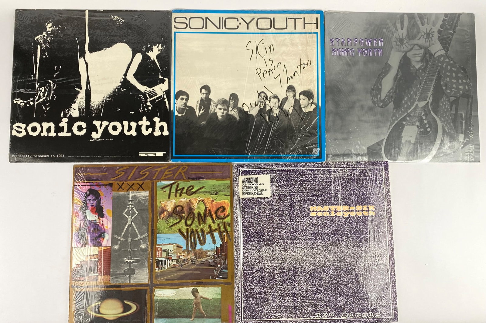 Collection of Six Sonic Youth Vinyl Records, Including Signed Item: Set of six vinyl records by Sonic Youth, featuring various albums and singles. Included is a signed copy of their self-titled 1982 album (signed by Thurston Moore and Kim Gordon with the phrase â