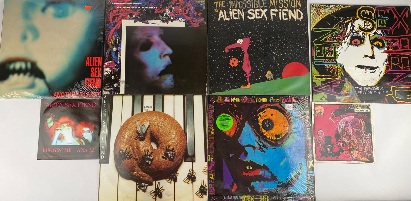 Collection of Eight Vinyl Records by Alien Sex Fiend with Multiple Titles: A collection of vinyl records and singles by Alien Sex Fiend, featuring multiple titles and albums, including â€˜Another Planet,â€™ â€˜The Impossible M
