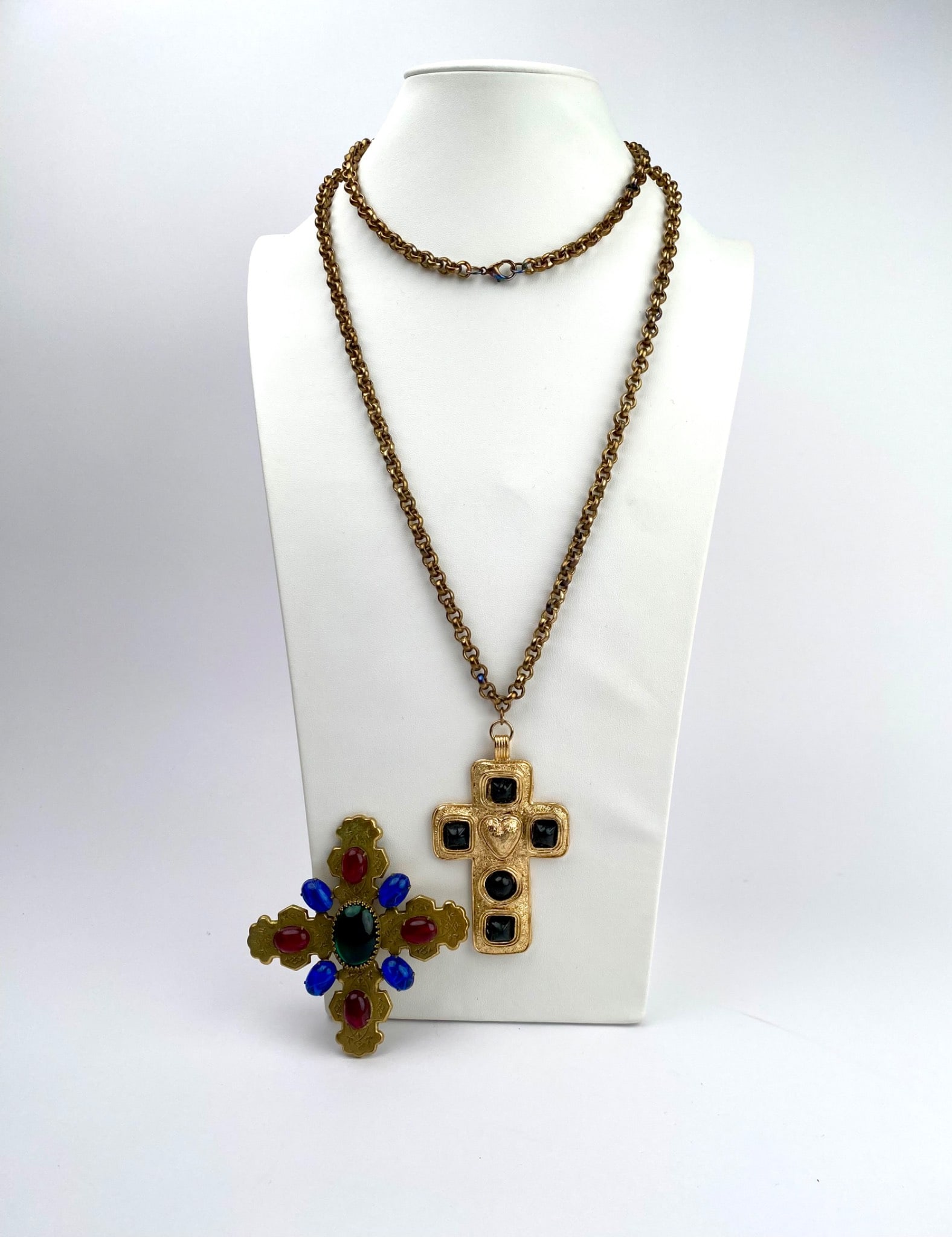 Vintage Byzantine-Styled Cross Necklace and Multicolored Brooch Set: Set includes a gold-tone cross necklace featuring textured surfaces and black stone accents along with a matching gold-tone chain. Also included is a multicolored brooch with a cross shape, decorated