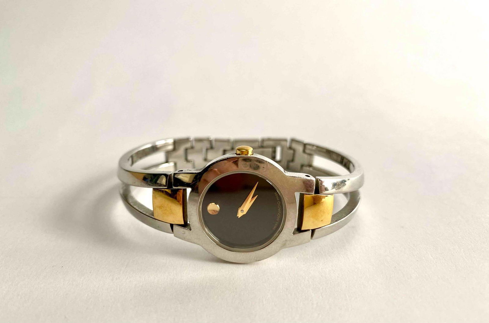 Movado Stainless Steel and Gold-Tone Women’s Bracelet Watch: Stainless steel Movado Amorosa women’s watch. Watch is made out of stainless steel and is silver in color with gold accents. Watch is in good condition and is stamped Movado and stainless steel like