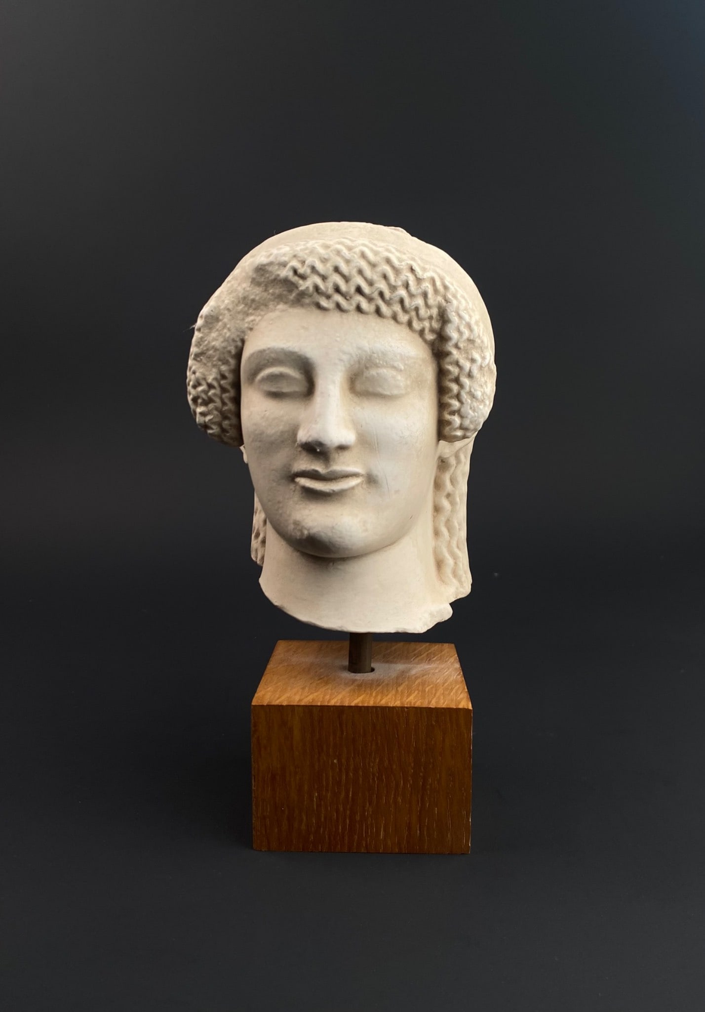 Museum-style Reproduction of Kore head from Eleusis (Attica): This piece is a museum-style reproduction of a Kore marble head originating from Eleusis (Attica), dated to approximately 490 B.C., representing late archaic art. Crafted from marble and featuring det