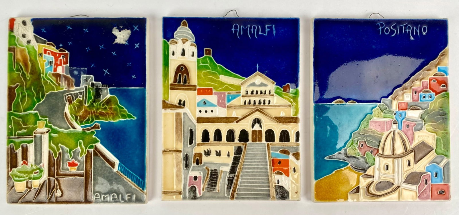 Set of Three Hand-Painted Ceramic Tiles Featuring Amalfi Coast Scenes: Set of three hand-painted ceramic tiles depicting scenes from Italyâ€™s Amalfi Coast, including views of Amalfi and Positano. Each tile features vibrant details and is signed with the