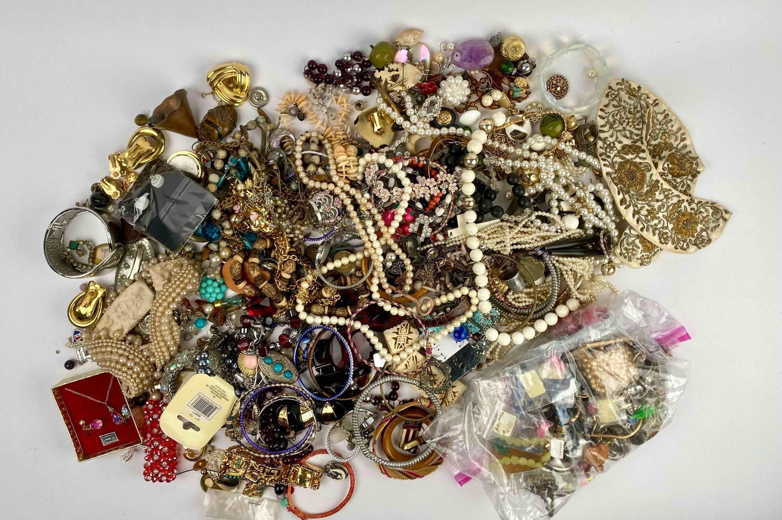 Bulk Lot of Assorted Jewelry: Huge lot of assorted jewelry. Lot includes but is not limited to rings, bracelets, necklaces and brooches. Please see photos for additional details.Diameter of Lot: 8 inches x 8 inches x 9 inchesLot W