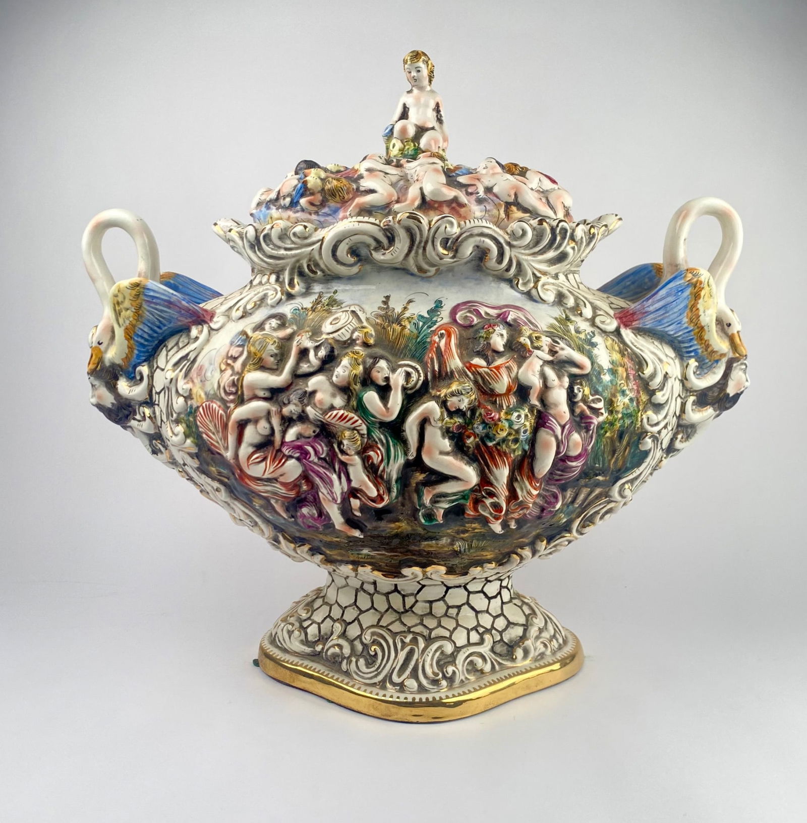 Capodimonte Lidded Porcelain Centerpiece by Bernini: A Capodimonte-style porcelain lidded centerpiece, intricately decorated with figural reliefs and gilt accents. This detailed piece features mythological and pastoral scenes in vibrant polychrome, pair