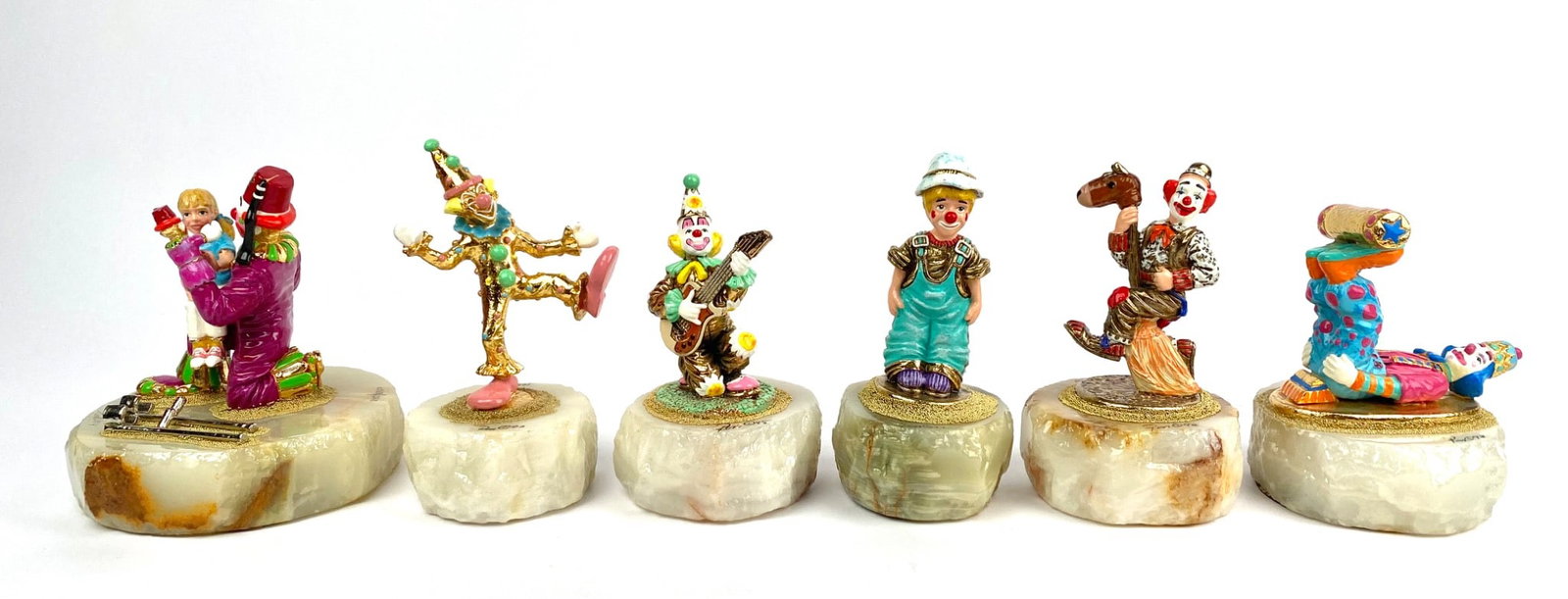 Set of Six Ron Lee Painted Clown Figurines on Onyx Bases (1993-1996): Set of six Ron Lee painted clown figurines, each featuring intricate details and varying poses. These figurines are bronze enamel mounted on natural onyx bases with felted bottoms. Some bases indicate