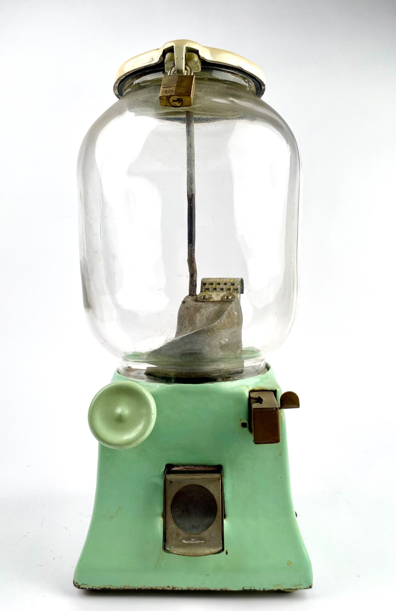 Northwestern 31 Porcelain Candy Dispenser: Mid-20th century coin-operated candy dispenser with a glass globe and green porcelain base. Features a coin slot and lever mechanism, along with a metal latch and padlock for securing the lid. Include