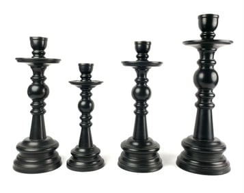 Four Black Painted Wooden Candlesticks in Graduated Sizes