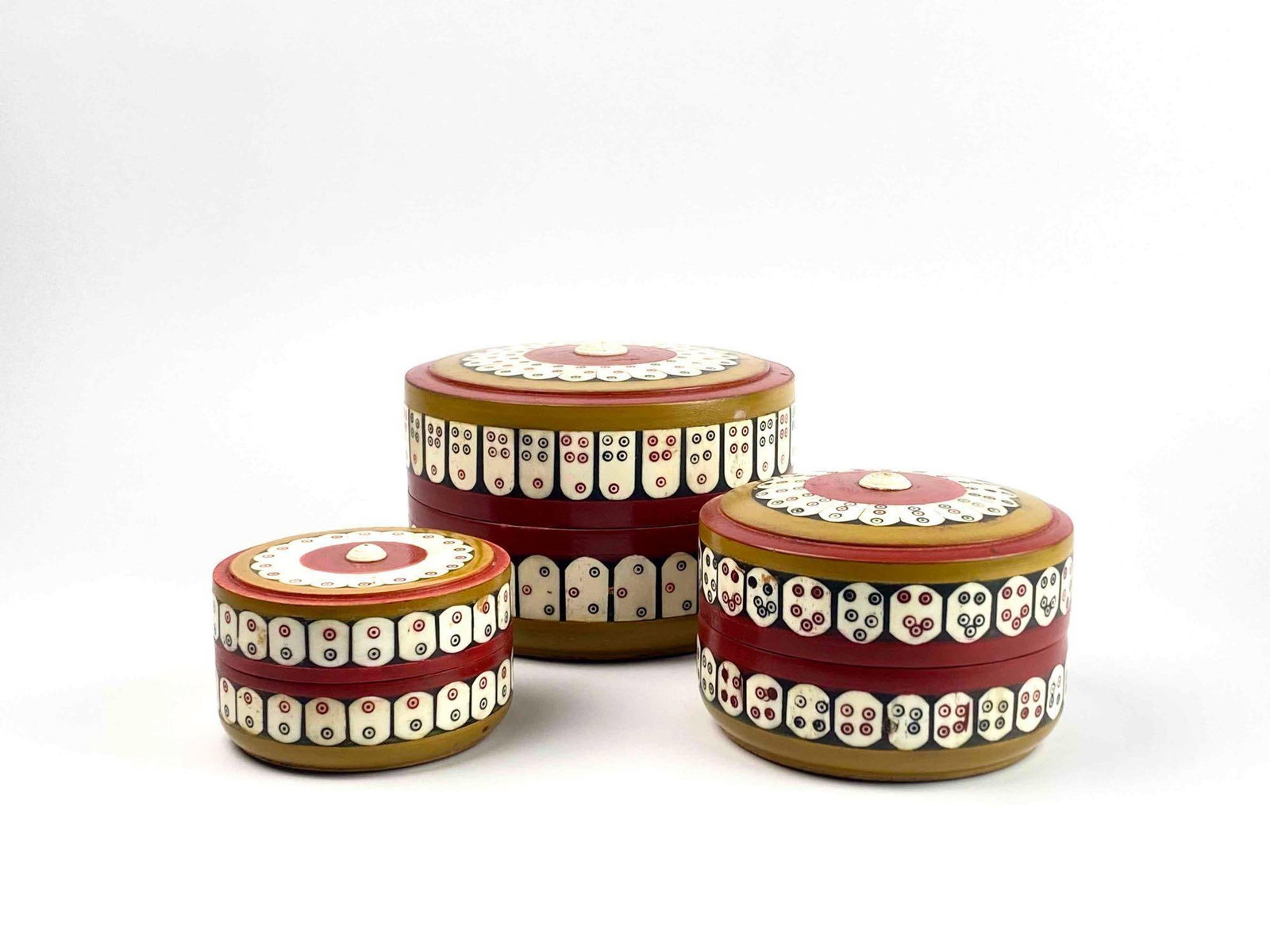 Three Wood and Inlaid Bone Nesting Boxes: Three wooden nesting boxes with inlaid bone and hand painted detail. Boxes have scalloped detailing on lid and wrapping around sides with painted dot accents. Boxes are in good condition with some are
