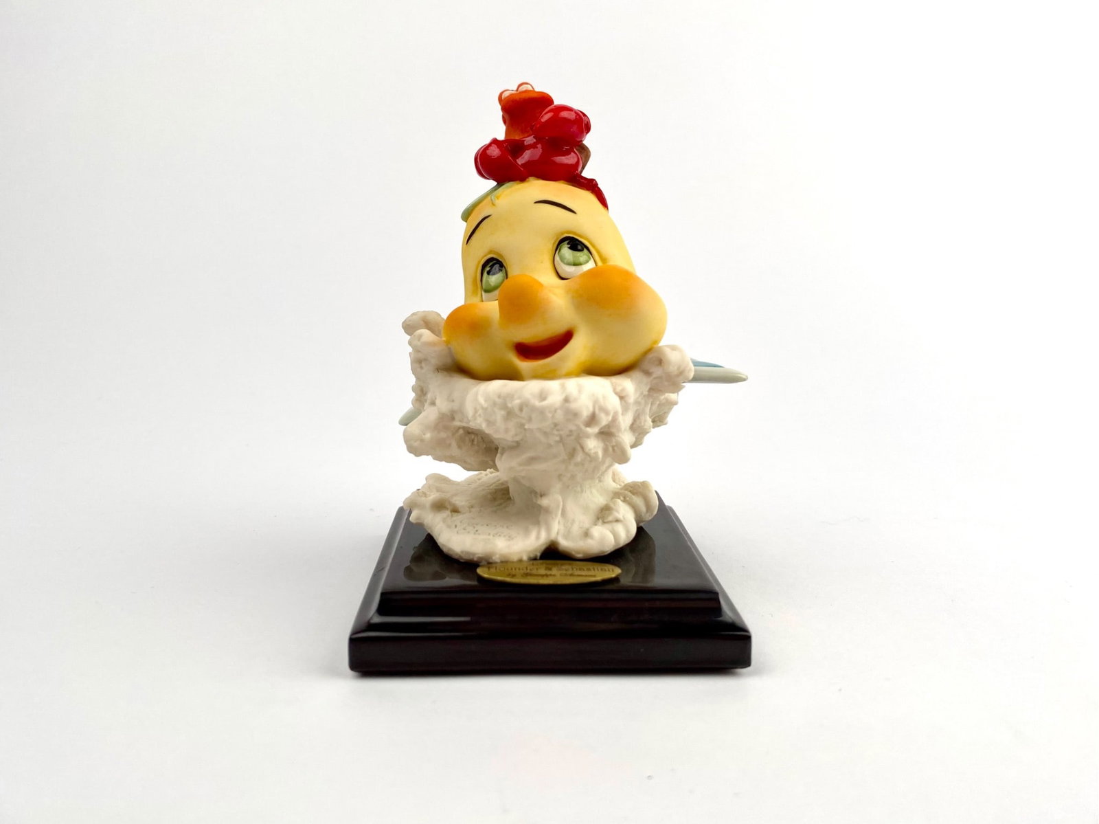 Giuseppe Armani Little Mermaid Flounder and Sebastian: Flounder and Sebastian figurine created by Giuseppe Armani for Florence Studios. Features vibrant colors and sculptural detailing on a dark wood base with a gold nameplate that reads Disney Flounder a