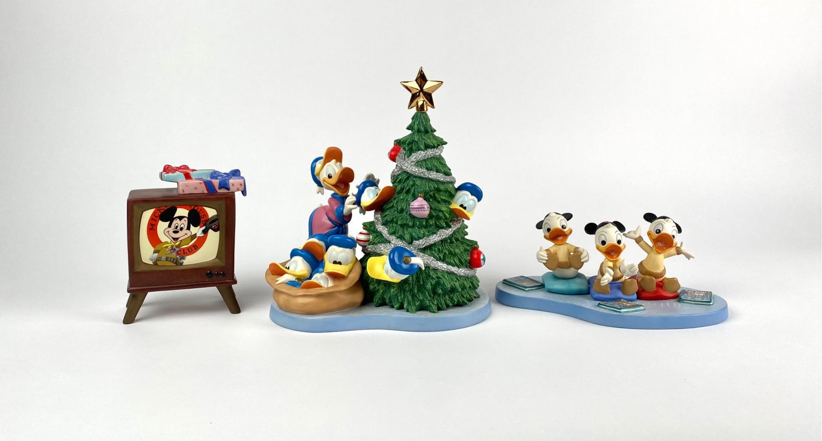 Disney Classics Collection Holiday Hat Trick (COA Original Box): Set of Walt Disney Classics Collection figurines titled Holiday Hat Trick, featuring characters Donald Duck, Huey, Dewey, and Louie. Includes three detailed scenes: Donald Duck decorating a Christmas 