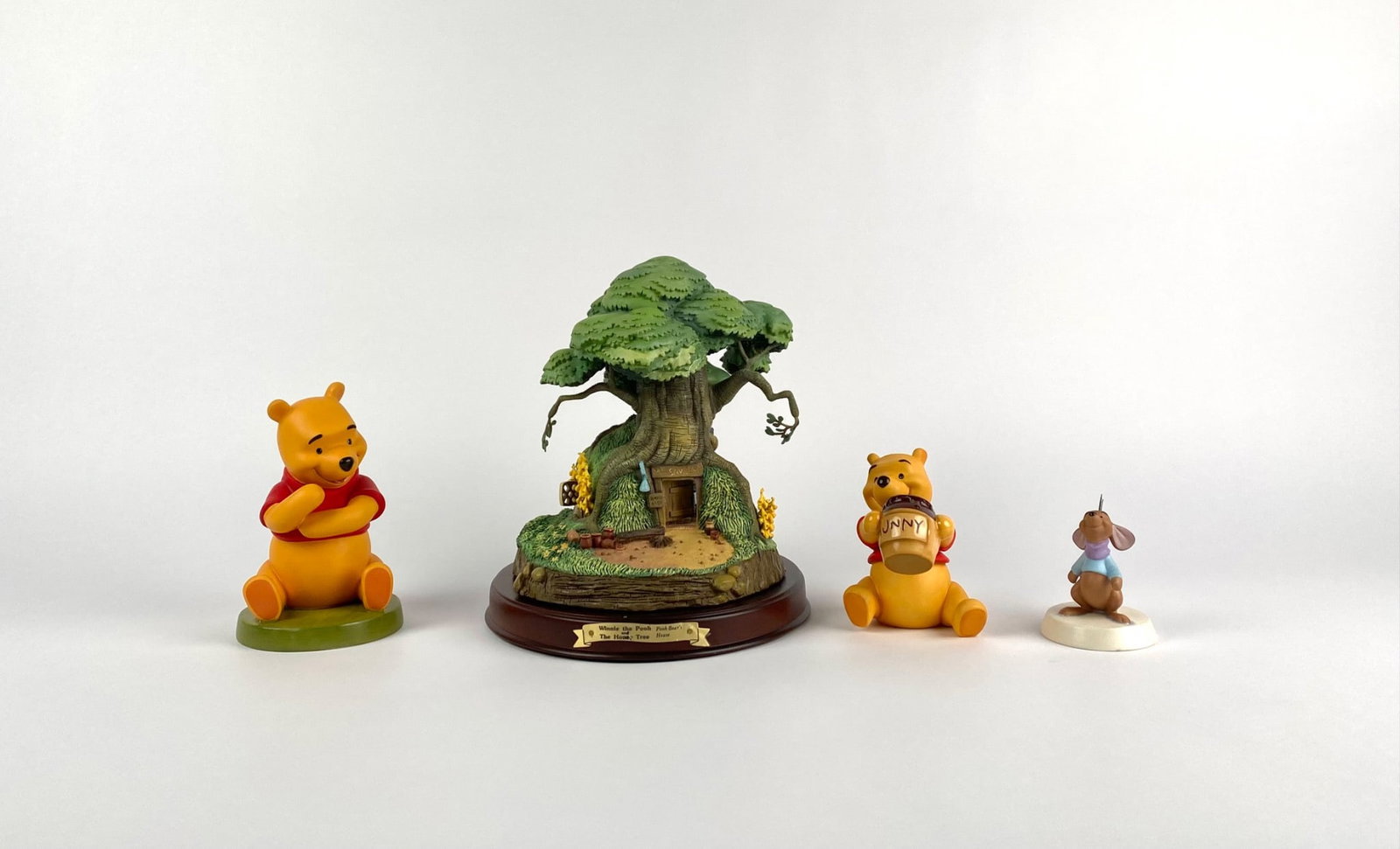 Disney Classics Collection Winnie the Pooh (COAs Original box): Set of four Disney Classics Collection figurines featuring Winnie the Pooh and related characters, including Pooh seated, Pooh with a Hunny jar, Roo, and the Honey Tree display. Accompanied by origina