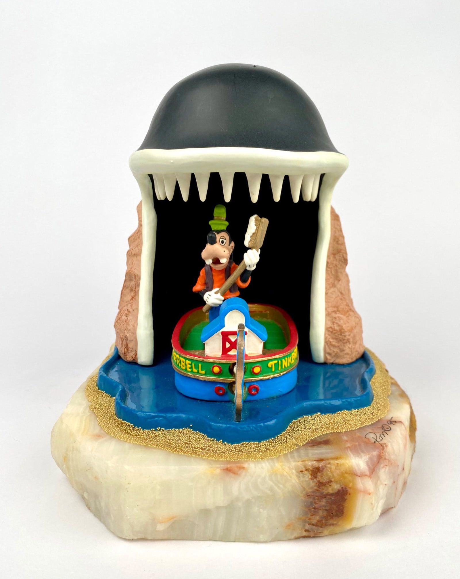 Ron Lee Disney Goofy and Monstro Figurine: Disney limited edition figurine showcasing Goofy in a boat named Tinkerbell within the jaws of Monstro the whale by Ron Lee. Mounted on a natural onyx base, the piece features vibrant paintwork. Hand-