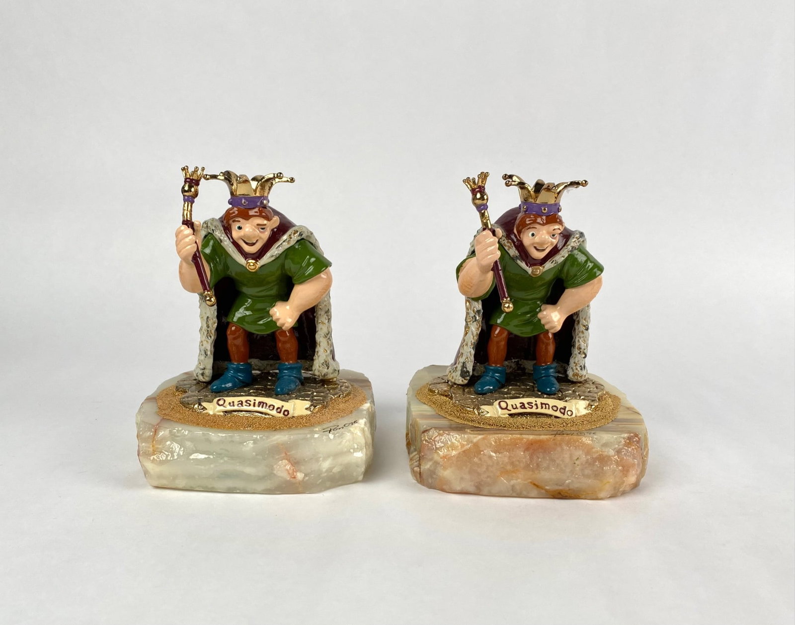Pair of Ron Lee Limited Edition Disney Quasimodo Figurines : Pair of limited edition Disney Quasimodo figurines, each hand-painted and mounted on a natural stone base. Features intricate details, including a jesterâ€™s crown and robe. Signed an