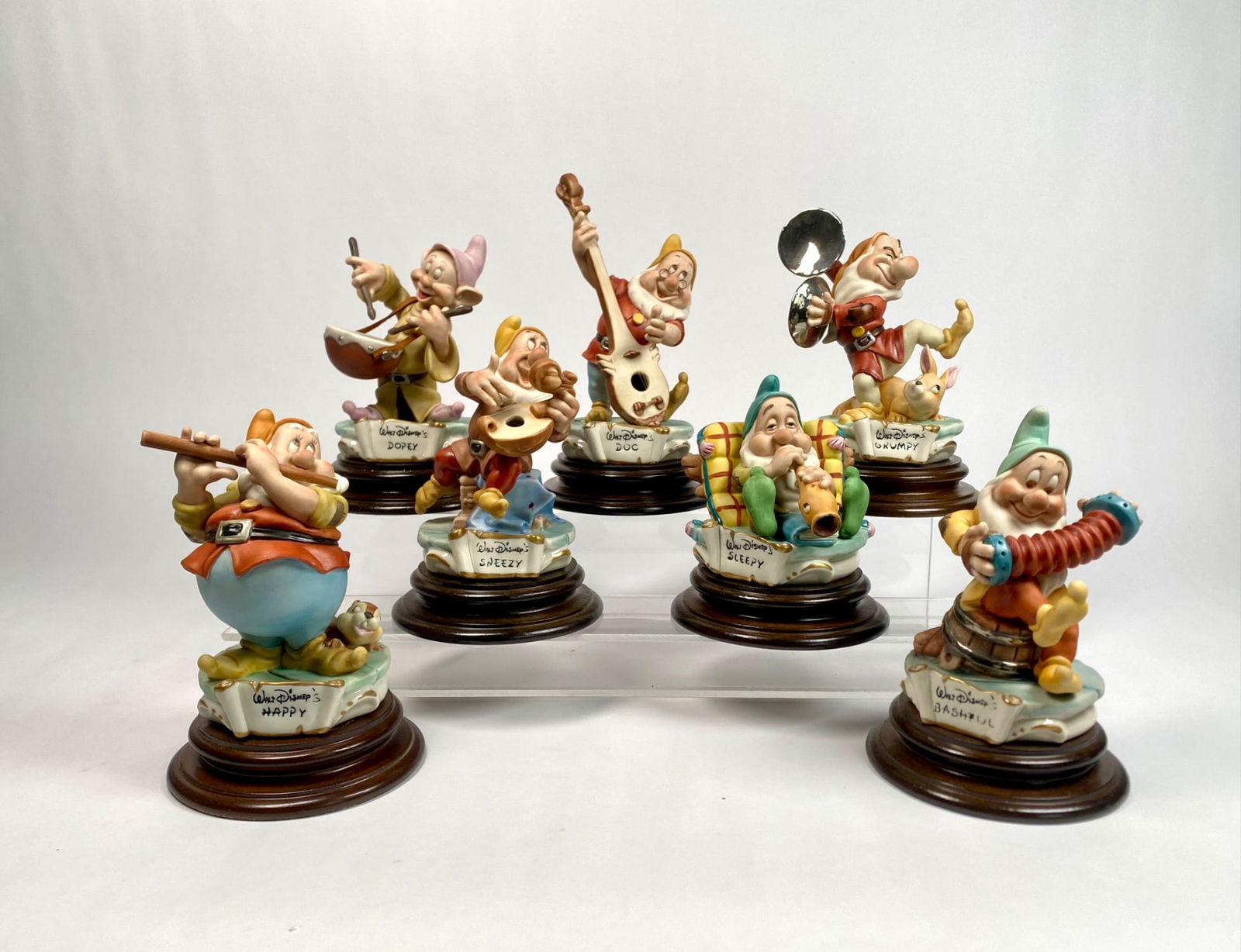 Disney Seven Dwarfs Musician Capodimonte Laurenz Figurines (1985): Set of seven hand-carved and painted ceramic figurines depicting Disneyâ€™s Seven Dwarfs as musicians by Capodimonte. Made in Italy, each figurine is mounted on a wooden base and mark