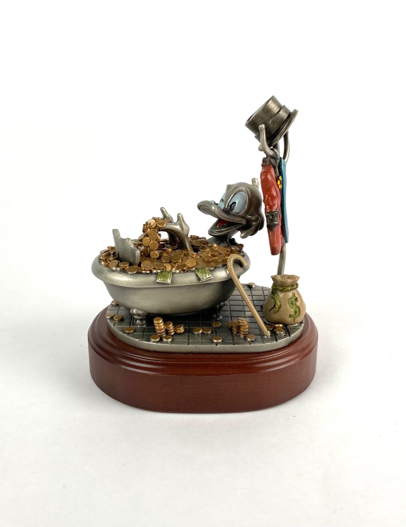 Hudson Creek Filthy Rich Pewter Figurine of Duck Bathing in Coins: Limited edition pewter figurine titled Filthy Rich, handcrafted at Hudson Creek in the USA. The piece depicts a duck character surrounded by a bathtub filled with coins, accompanied by accessories lik