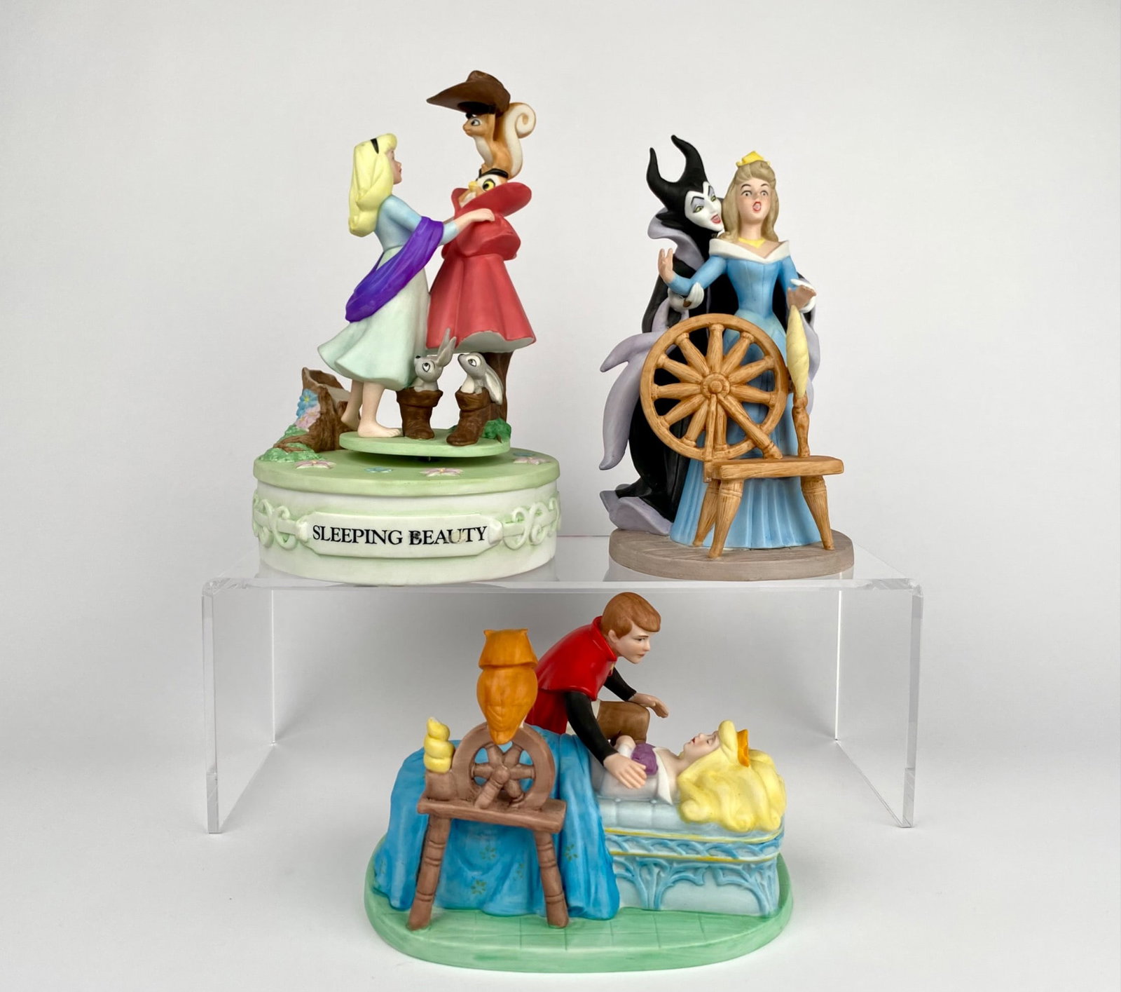Set of Three Disney Sleeping Beauty Ceramic Figurines: Set of three Disney Sleeping Beauty-themed figurines including The Disney Collection Musical Memories figurine, The Disney Collection Villains Heritage Maleficent figurine, and The Disney Collection M