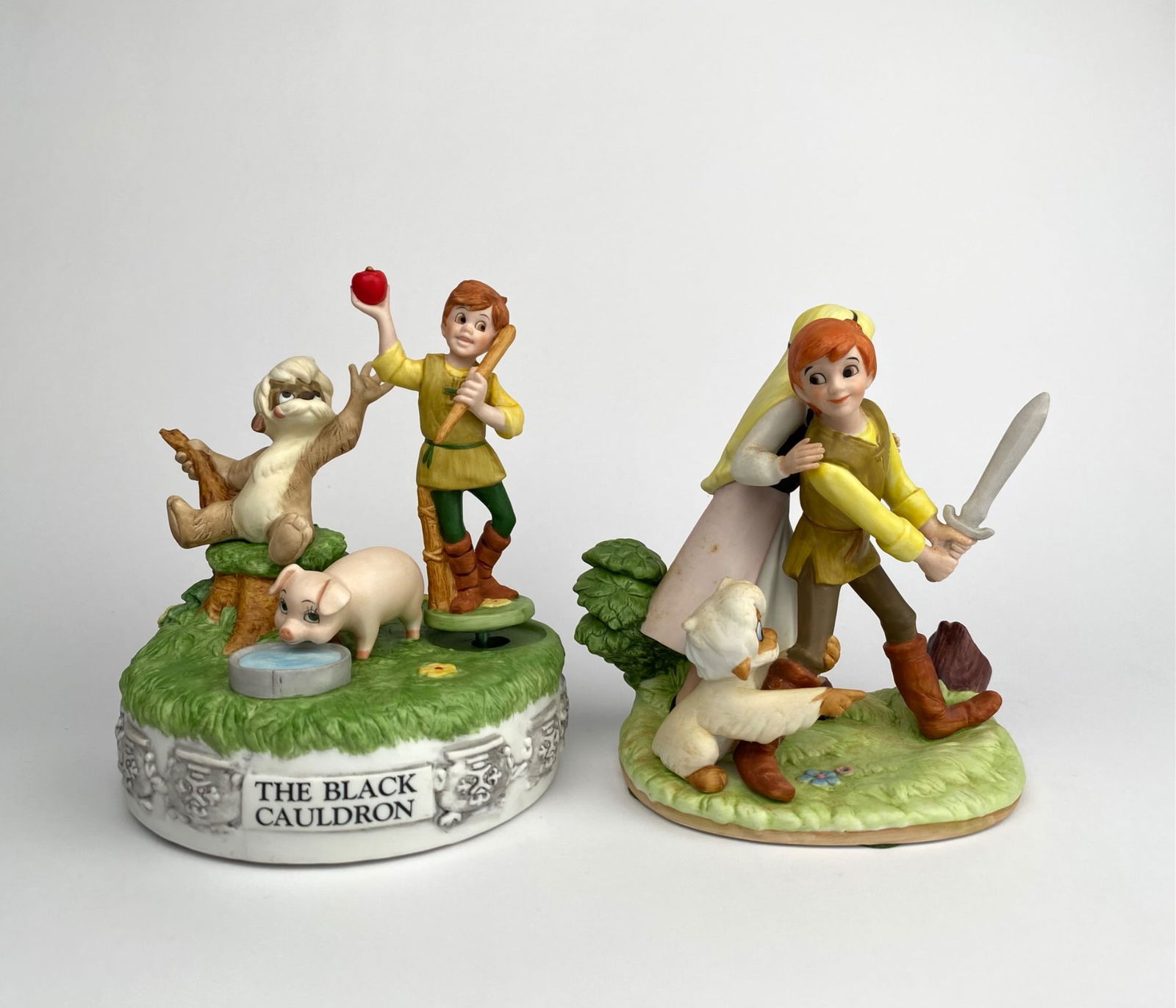 Disney Magic Memories The Black Cauldron Pair of Figurines: Pair of collectible figurines from Disneyâ€™s Magic Memories series, featuring characters from The Black Cauldron. One figurine includes Taran, Hen Wen, and Gurgi on a music box base.