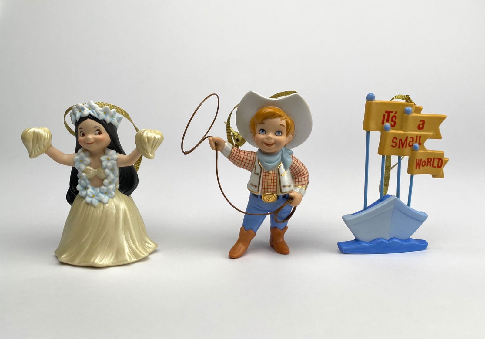 Disney Its a Small World After All Ornament Set (COAs Original Boxes): Set of three Disney Itâ€™s a Small World After All ornaments, including Hawaiian Girl, Howdy Partner, and Sailboat designs. Each ornament is crafted in resin, features a gold hanging
