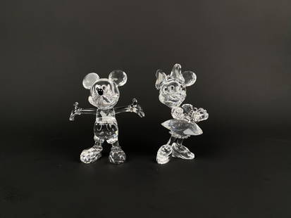 Swarovski Crystal Mickey and Minnie Figurines: A pair of Swarovski crystal figurines featuring iconic characters Mickey Mouse and Minnie Mouse meticulously crafted with precision cut clear crystals. Both figurines display detailed features and cla