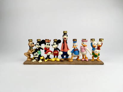 Disney Menorah with Mickey and Friends: A hand painted polystone Menorah featuring Disney characters including Mickey Mouse, Minnie Mouse, Donald Duck, Daisy Duck, Pluto, Goofy, and Huey, Dewey, and Louie. Each character holds a gold toned