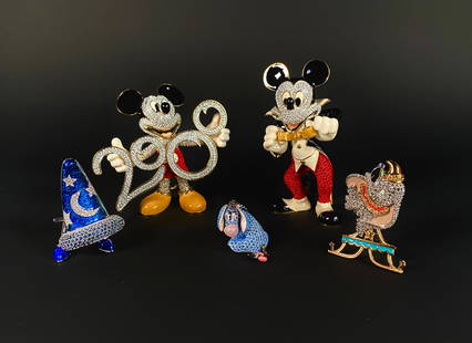 Disney Disneyana and Swarovski Gem Figures: Collection of Disney Disneyana and Swarovski gem figures. Includes two Mickey Mouse figures, one holding a 2000 sign, and the other holding a golden bow tie. Additional pieces feature representations