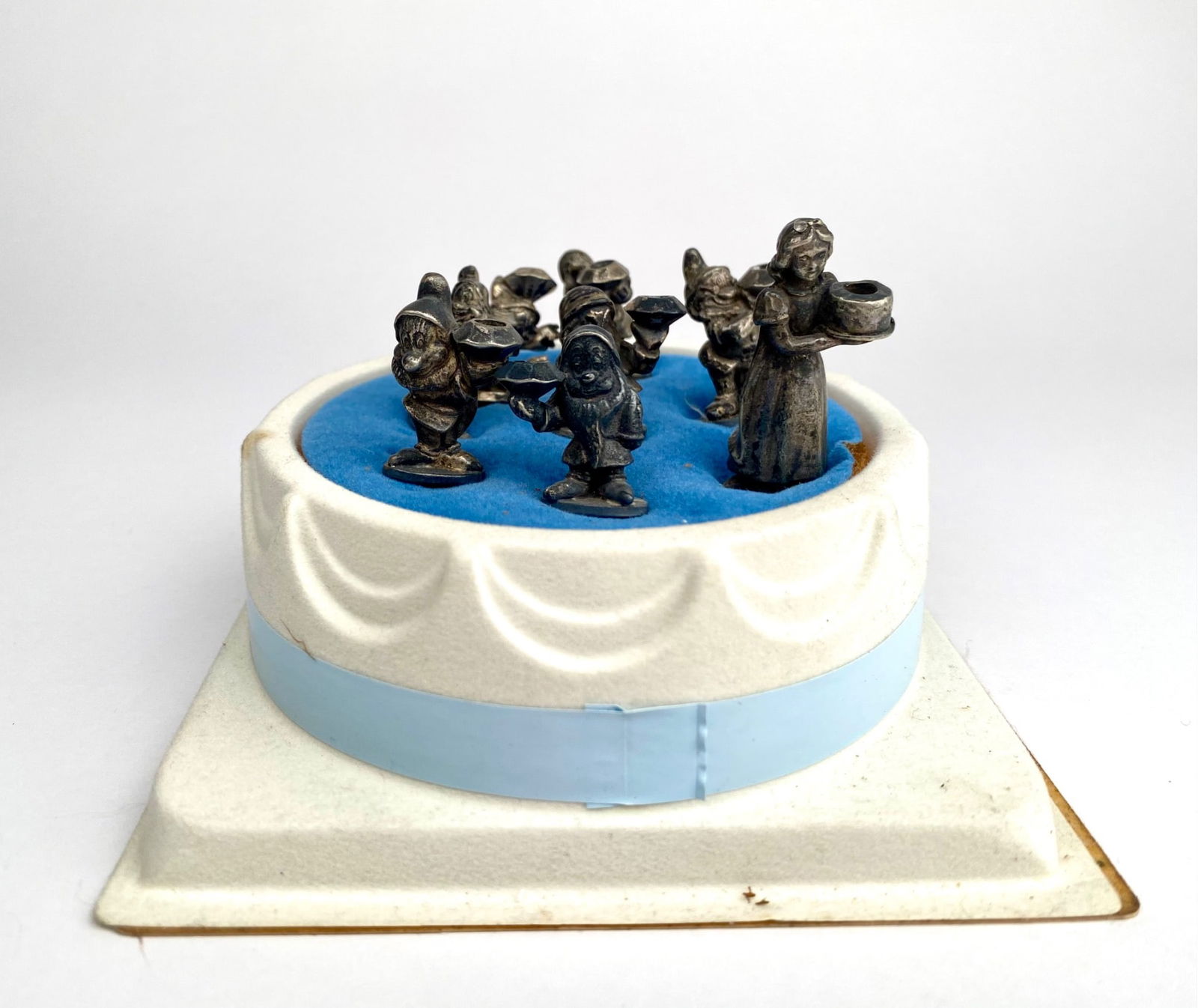 Disney Character Pewter Birthday Candle Holders by Reed and Barton: Set of pewter birthday candle holders by Reed and Barton, depicting Disney characters including Snow White and the Seven Dwarfs. Each holder includes a pointed base for placement on cakes or similar s