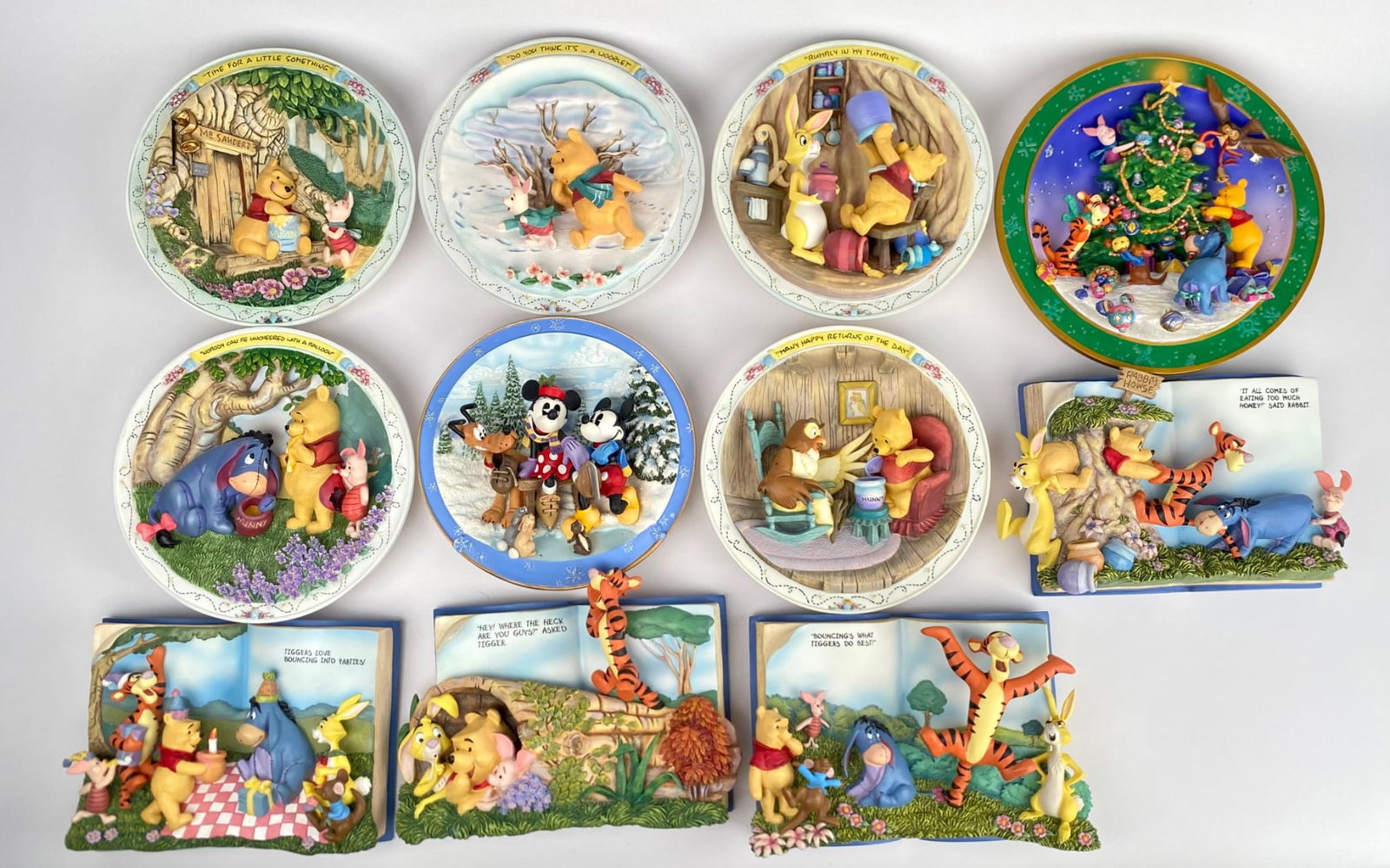 Set of Pooh Collectible Plates and Figurines by Schmid: Set includes a total of 11 collectible plates and four book like figurines, all featuring Winnie the Pooh and characters from the Hundred Acre Wood. The plates are crafted by Schmid and Disney, with d