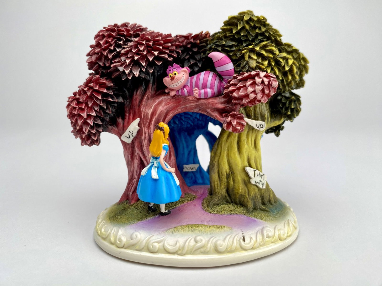 Olszewski Storytime Disney Alice in Wonderland Figurine?: Disney figurine depicting Alice and the Cheshire Cat under colorful trees with directional signs labeled Up, Down, and That Way. Crafted in 2005 as part of a limited edition collection by Walt Disney 